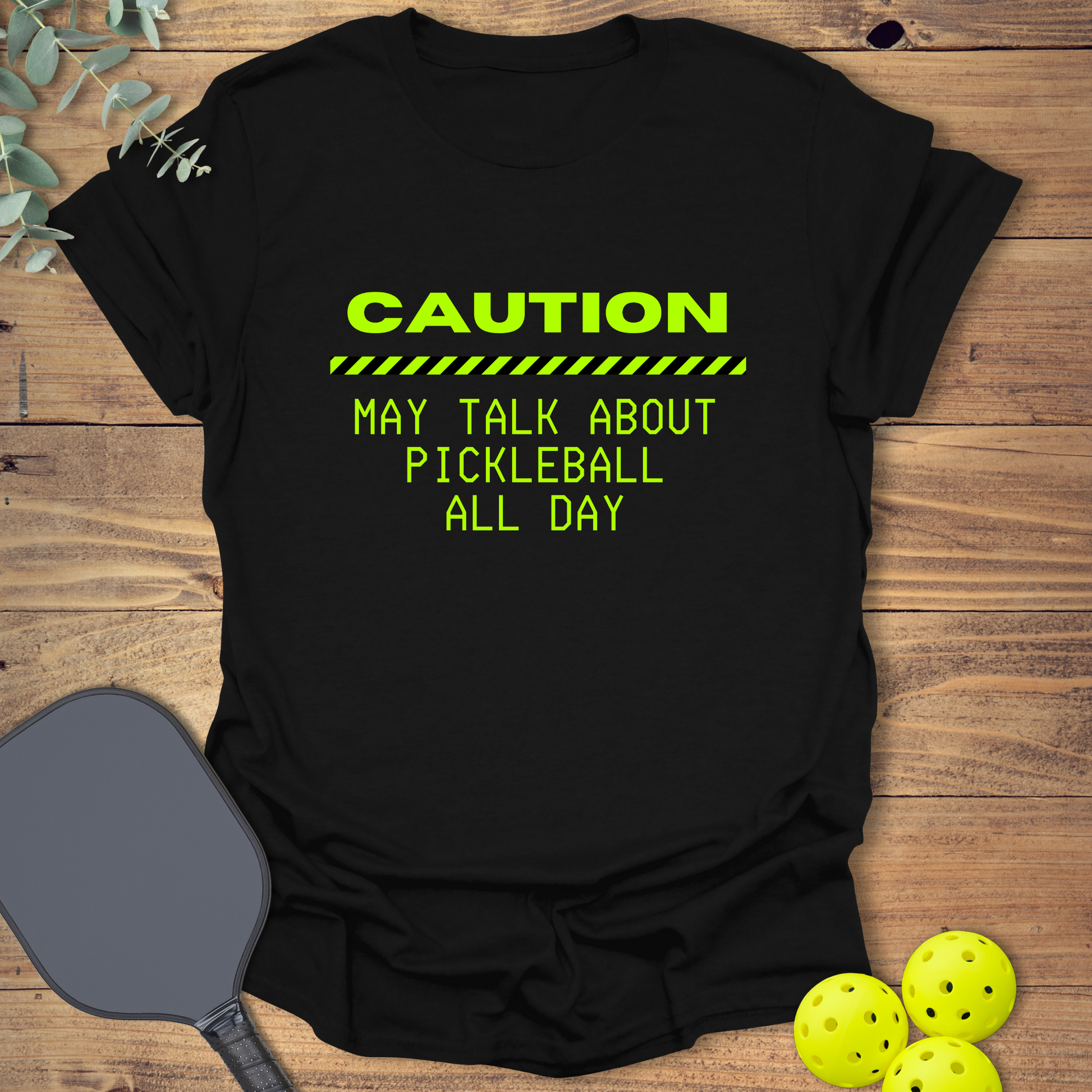 Black pickleball sweatshirt with neon green text that reads “Caution: May Talk About Pickleball All Day” and a caution stripe graphic.