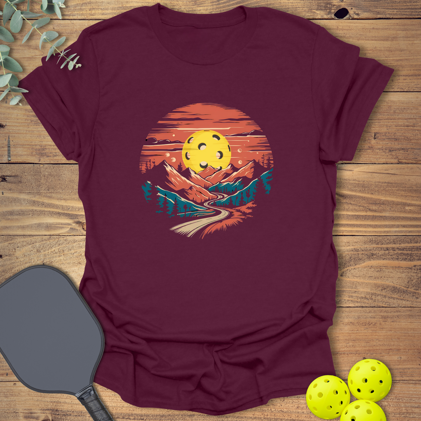 Beautiful pickleball t-shirt with a mountain landscape design in maroon