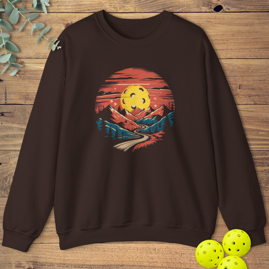 fun pickleball sweatshirt with a mountain sunset design in dark brown