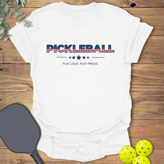 Patriotic pickleball t-shirt with American flag lettering and "Play Loud. Play Proud." slogan in white