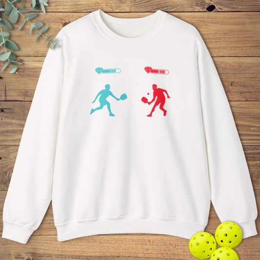 White unisex pickleball sweatshirt with two video game characters holding pickleball paddles, facing off with health bars above them. Gamer battle design.