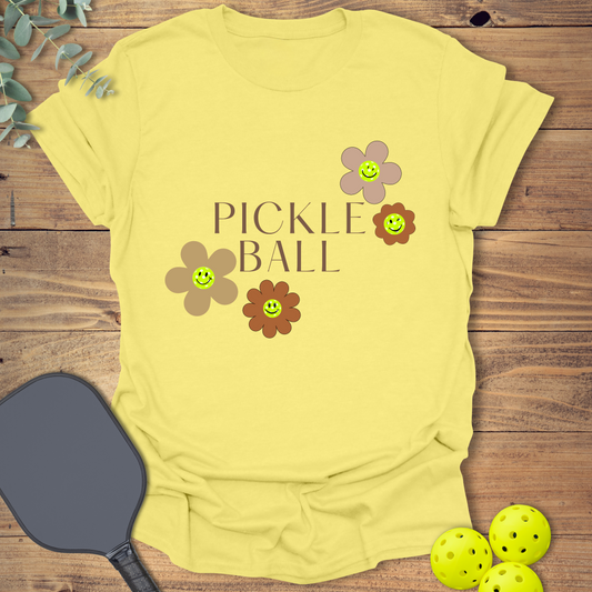 Fun pickleball t-shirt with a happy flower design in light yellow