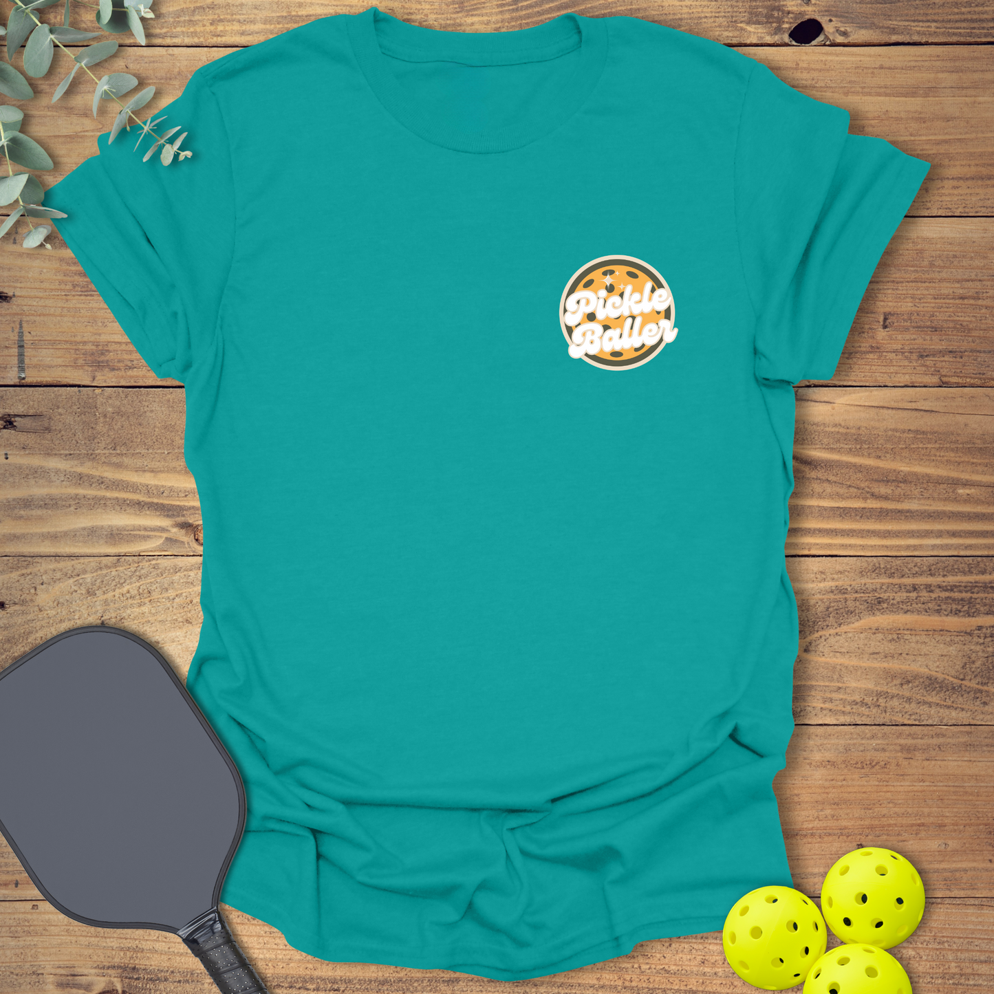 Fun pickleball t-shirt with a retro-style design in jade blue
