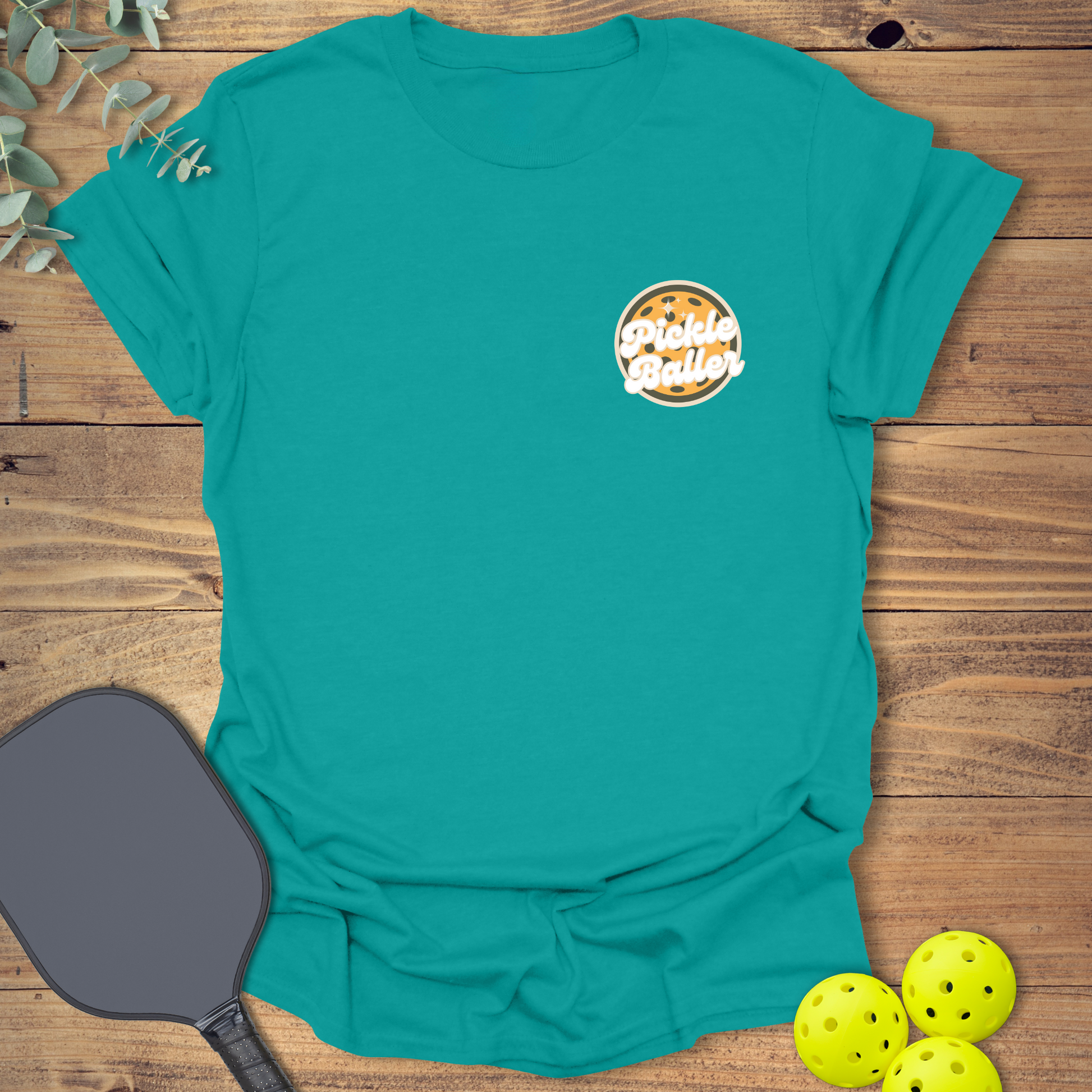 Fun pickleball t-shirt with a retro-style design in jade blue