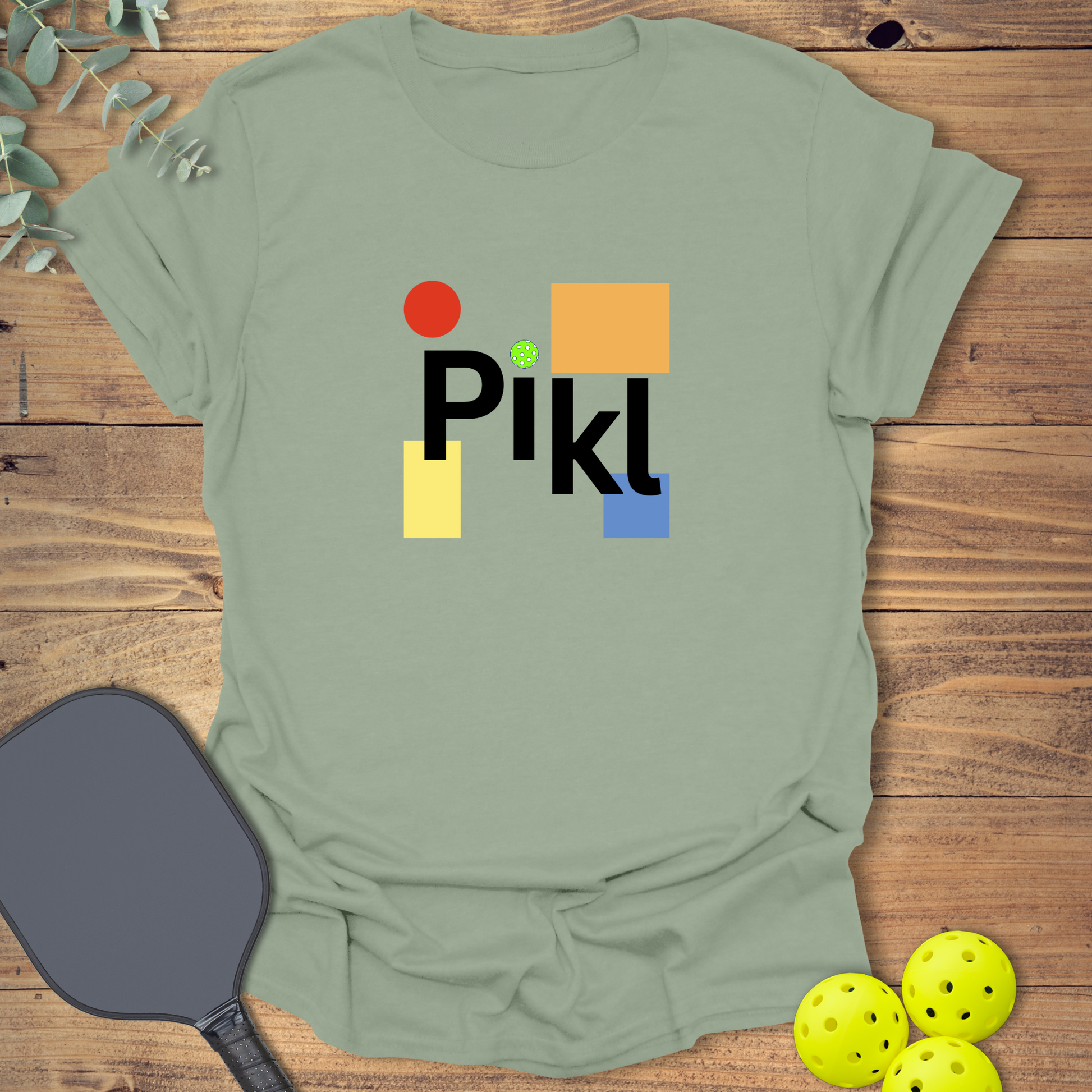 Graphic pickleball t-shirt with a geometric design in sage green