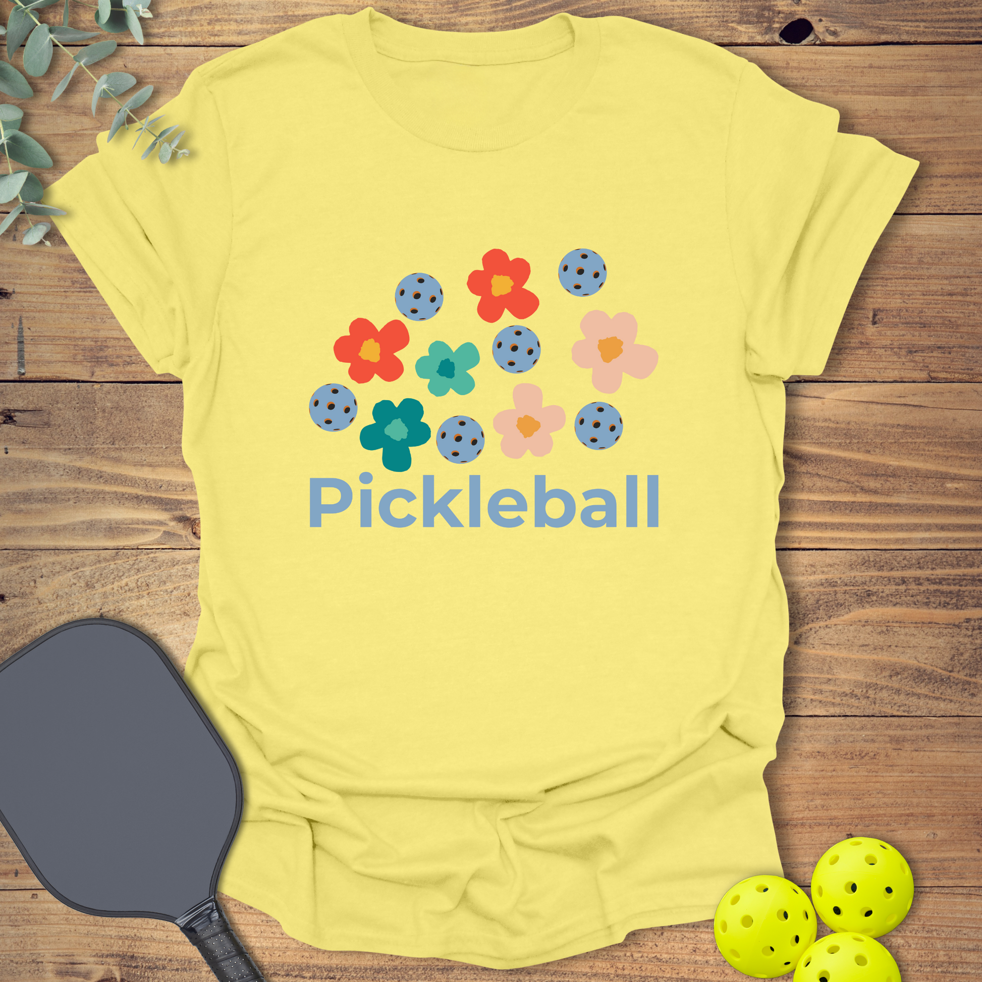 Cute pickleball t-shirt with a retro-style flower design in light yellow